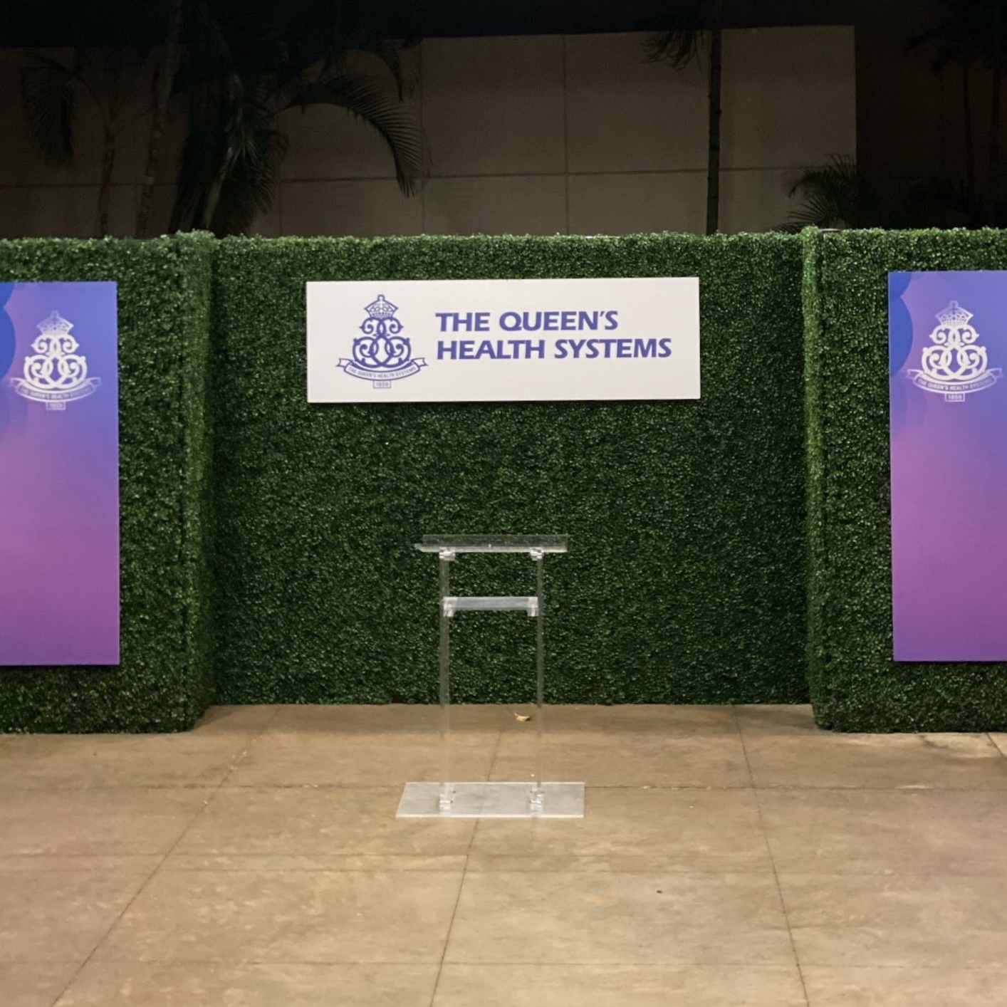Faux Boxwood panels with Queen's Health Systems Signs
