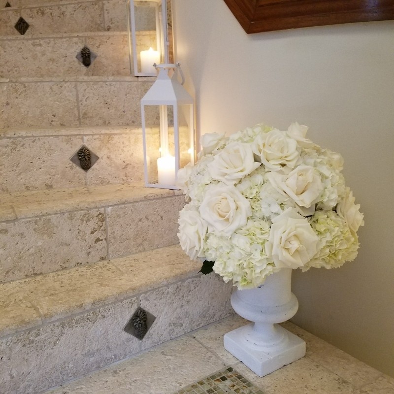 White lantern with candle on stairs