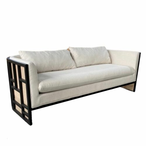 Rattan barrel sofa with cream cushions