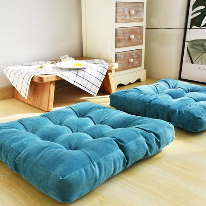 Teal Square Pillow on floor